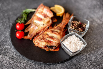 baked red sea bass on a stone background