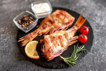 baked red sea bass on a stone background
