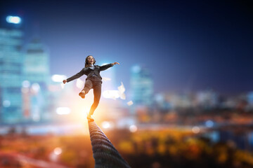 Fototapeta na wymiar Image of businesswoman balancing on rope. Risk concept