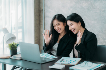 Asian woman sitting at a desk working in the office use a computer, laptop