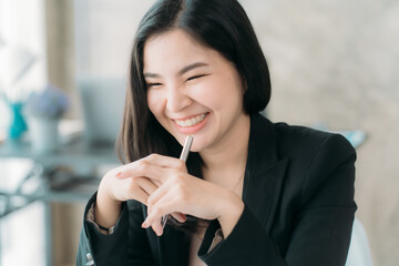 Businesswoman or accountant using the phone to check business information. Accounting Documents and Laptop Computer at Office Business Ideas