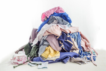 Used clothes in a pile. Sorting and cleaning second-hand. Preparing for washing. Copy space on...