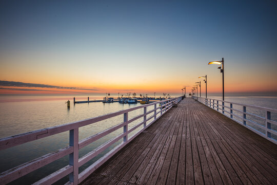 Sunrise over the pier in Mechelinki. © R_Szatkowski