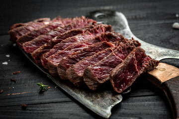 Barbecue dry aged wagyu porterhouse steak, grilled medium rare beef steak with spices served on old meat butcher. sliced. top view