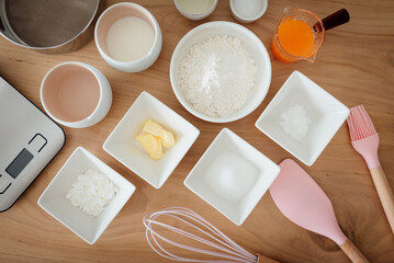A set of ingredients and tools for baking an orange cake.
