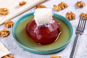 Quince dessert. Traditional Turkish cuisine delicacies. Quince dessert with cream on a stone background. Close-up. local name ayva tatlisi