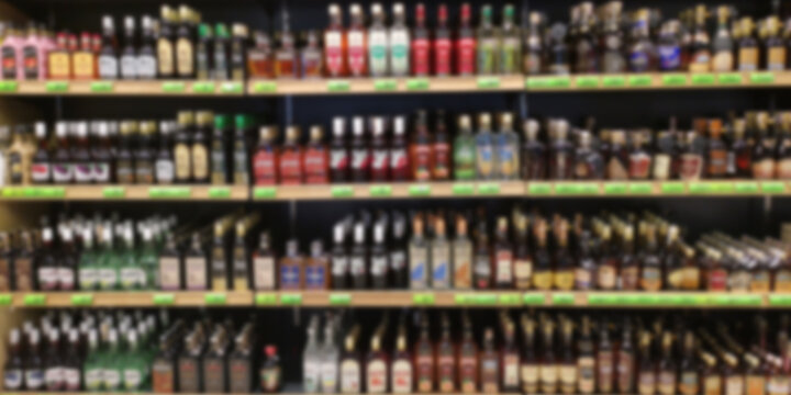 Alcohol showcase blurred background. Blurred abstract background of shelf in supermarket