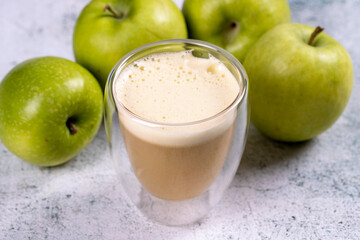 Apple juice. Freshly squeezed juice. Freshly squeezed apple juice in glass on stone background. Close-up