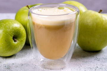 Apple juice. Freshly squeezed juice. Freshly squeezed apple juice in glass on stone background. Close-up