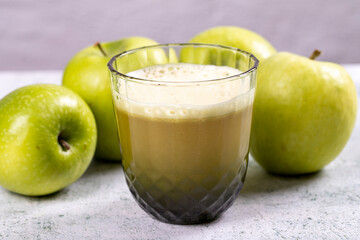 Apple juice. Freshly squeezed juice. Freshly squeezed apple juice in glass on stone background. Close-up