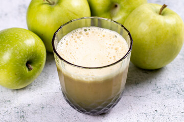 Apple juice. Freshly squeezed juice. Freshly squeezed apple juice in glass on stone background. Close-up
