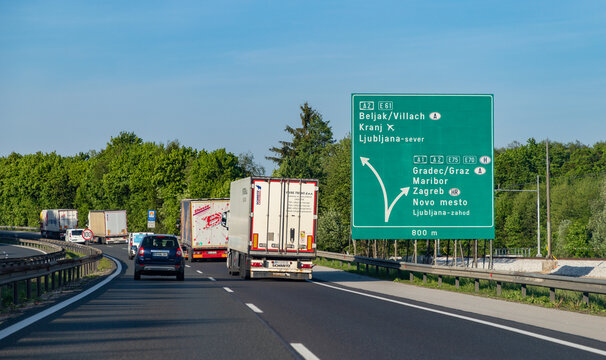Ljubljana, Slovenia - May 11, 2022: A picture of a large green sign pointing to destinations in 4 different countries on a Slovenian highway.
