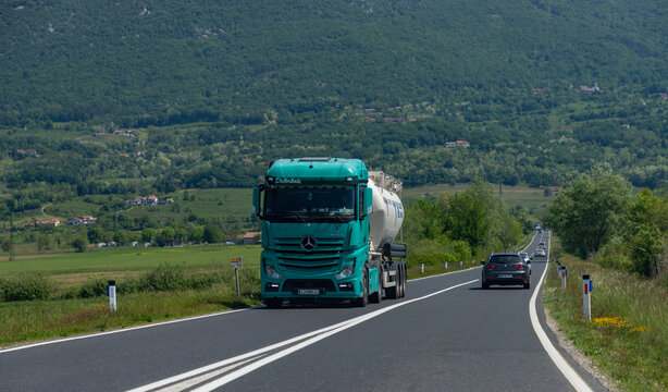 Nova Gorica, Slovenia - May 11, 2022: A picture of a truck driving on a countryside road.