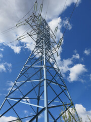 geometric design of a power line tower against a blue sky background