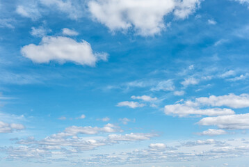 Naklejka na ściany i meble Panoramic background of blue sky with white cumulus clouds. white cloud on blue sky. some white whispy clouds and blue sky cloudscape. Beautiful blue sky and clouds natural background.