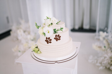 Unusual holiday wedding cake for pet lovers with a cat paw print on the cake
