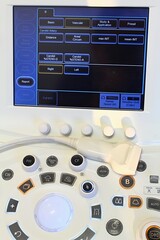Large touchscreen and control panel of modern diagnostic medical ultrasound machine with linear...