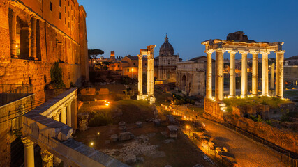 The Roman Forum (latin name Forum Romanum) at night, plaza of the ancient roman ruins at the center...