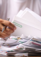Close-up of business man's hands in white shirt searching for signed documents, business concept