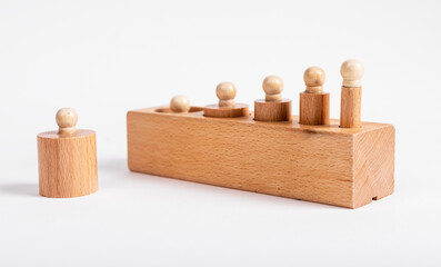 Montessori knobbed wooden cylinders incorrectly placed in block. Error in puzzle assembly. Kids...