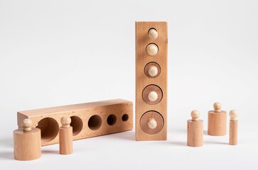 Montessori knobbed wooden cylinders with blocks. Childish puzzle for development of size perception...