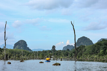 Couple kayaking in wild river for siummer vacation concept.