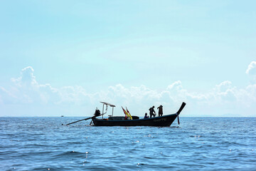 Silhouette of fisherman catch fish on the ocean in Thailand. 