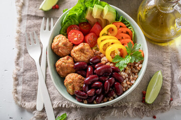 Healthy Mexican salad with meatballs, beans, pepper and groats.