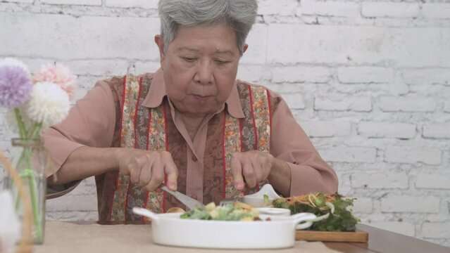 Old Elderly Senior Elder Woman Eating Grilled Pork Chop Steak Food. Mature Retirement Lifestyle