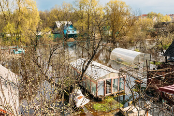 Vegetable Garden Beds In Water During Spring Flood floodwaters during natural disaster. Greenhouse...