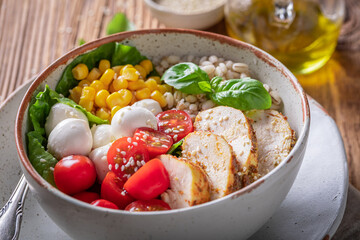 Fresh Caesar salad with cheese, chicken and groats.