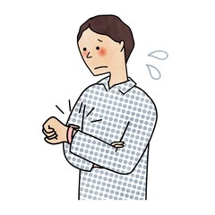 腕時計を見ながら困る男性
