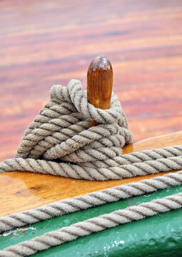 Hemp rope on deck railing of vintage sailing ship