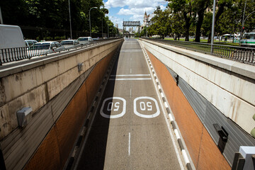 Route, highway, road, way down SELECTIVE FOCUS. Top view of empty paved road with marking signs for 50 km per hour traffic restriction. Urban infrastructure, cityscape background. Travel Madrid, Spain