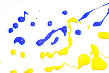 Yellow and blue paint splater reflecting the national colors of Ukraine..   Abstract image of yellow and paint splatter on white background