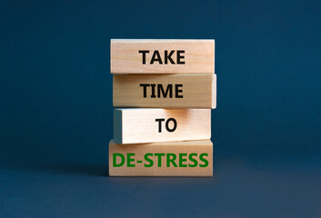 Take time to de-stress symbol. Concept words Take time to de-stress on wooden blocks. Beautiful grey table grey background. Psychological business and take time to de-stress concept. Copy space.