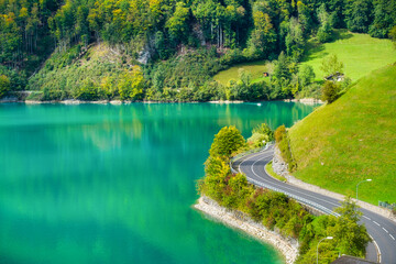 Lungern, canton of Obwalden, Switzerland. The road by the shore of the lake. A lake in a mountain...