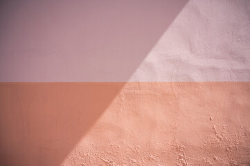 Texture background; wall painted in two different colours with a shadow over it