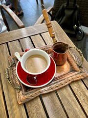 cup with coffee and cezve on a vintage tray