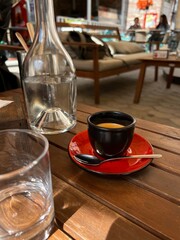 black espresso cup on wooden table outdoor