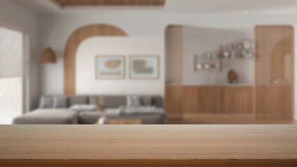 Empty wooden table, desk or shelf with blurred view of living room with sofa, kitchen with cabinets, modern interior design concept