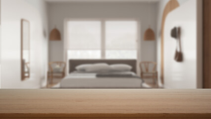Empty wooden table, desk or shelf with blurred view of cozy bedroom, bed with pillows and decors, chairs and big window, modern interior design concept
