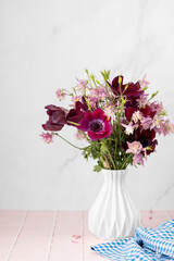 Vase with beautiful flowers bouquet on table against white background. Space for text