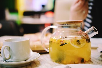 yellow lemon fruit tea in a transparent teapot