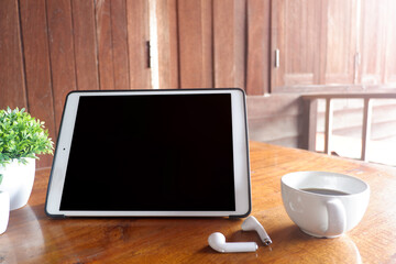 Cropped shot view of tablet and office desk table with the office equipments, and other office supplies on the modern space, flat lay.work at home.