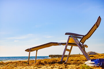 Deckchair on sandy beach