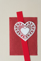 fancy doily heart on red and beige paper - obrazy, fototapety, plakaty