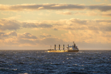Cargo vessel at sea. Beautifil light - golden hour.