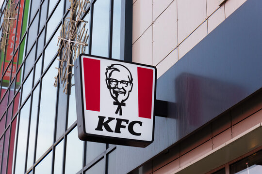Krasnoyarsk, Russia - May 29, 2022: KFC restaurant logo on facade. Portrait of Colonel Sanders - the symbol of the KFC. KFC is a fast food restaurant chain specializes in fried chicken