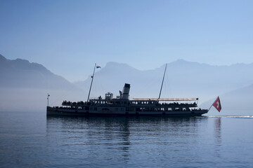 Tourist boat in Lake Lucerne with the Alps behind